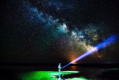 Scenic view of sky over lake at night