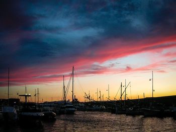 Sailboats in marina at sunset