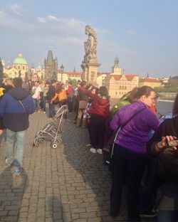 Rear view of people walking in town square