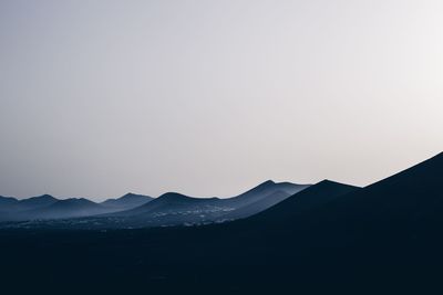 Scenic view of silhouette mountains against clear sky