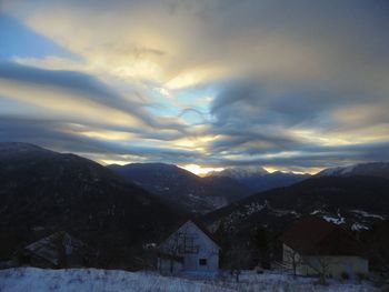 Scenic view of snow covered mountains against sky