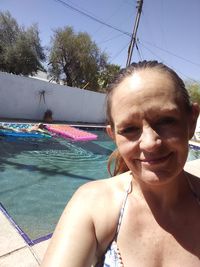 Portrait of smiling woman in swimming pool