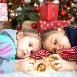 Cute boy and girl on christmas tree