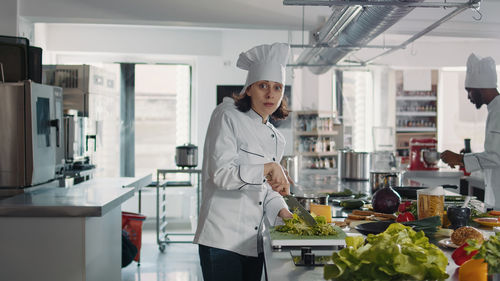 Portrait of young woman standing in laboratory