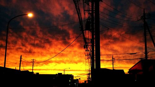 Low angle view of electricity pylon against sky