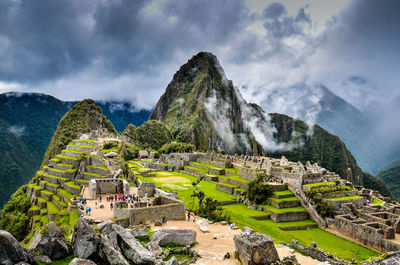 Panoramic view of old ruins against cloudy sky