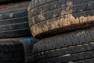Stack of old tires. pile of used tires. black rubber tire of car. dirty used tyres. closeup old tyre