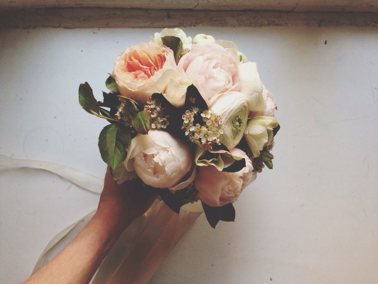 flower, indoors, freshness, rose - flower, vase, table, fragility, petal, close-up, still life, bouquet, home interior, wall - building feature, high angle view, flower head, rose, pink color, plant, wood - material, day