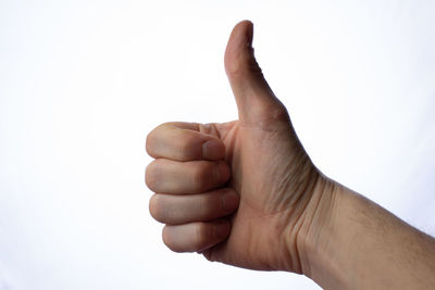Close-up of human hand against white background