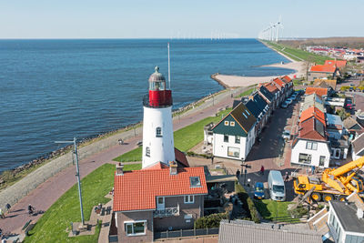 High angle view of townscape by sea against sky