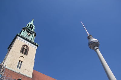 Low angle view of tv  tower and church against sky