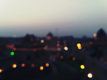 Defocused image of illuminated city at night