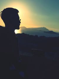 Silhouette man against sky during sunset