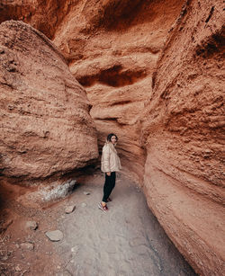 Rear view of woman standing on rock