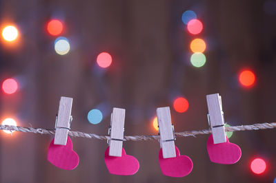 Close-up of illuminated lanterns hanging in city at night