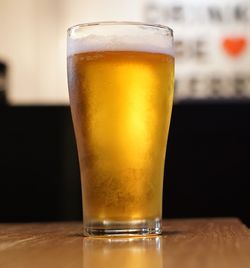 Close-up of beer glass on table