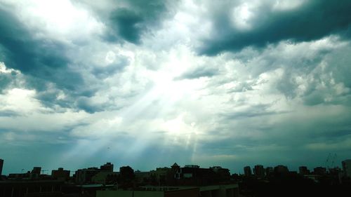 Cityscape against cloudy sky