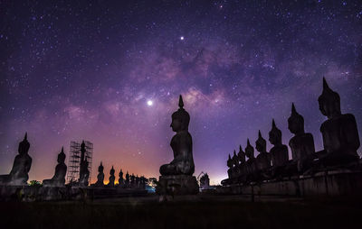 Low angle view of buildings against sky at night