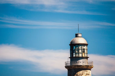 High section of lighthouse against sky