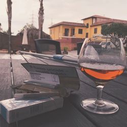 Close-up of beer glass on table in city