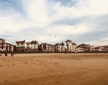 Buildings by sea against sky in city