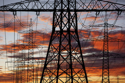 Low angle view of electricity pylon against sky