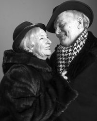 Senior couple against gray background