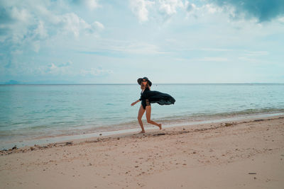 Full length of man on beach against sky