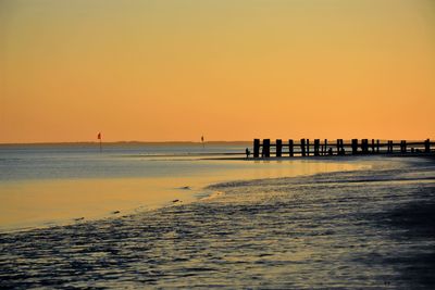 Scenic view of sea against clear sky during sunset