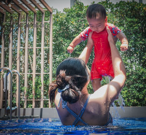 High angle view of boy playing in swimming pool