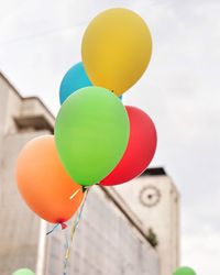 Low angle view of balloons against sky