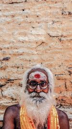 Portrait of man wearing mask against wall