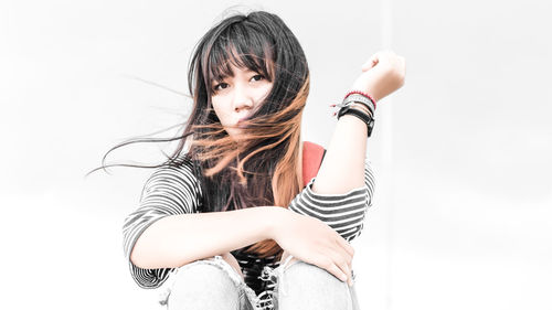 Portrait of young woman with tousled hair