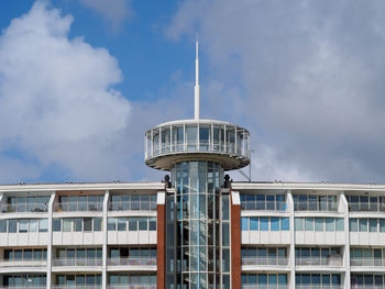 Low angle view of building against cloudy sky