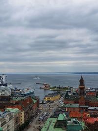 High angle view of buildings by sea against sky