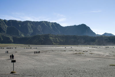 Scenic view of land and mountains against sky