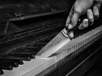 Knife cutting a piano like a cake