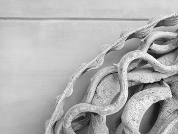 Close-up of rope on table against wall