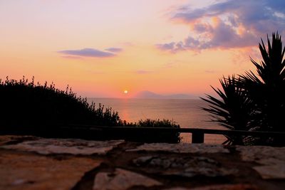 Scenic view of sea against romantic sky at sunset