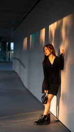Portrait of young woman standing on street