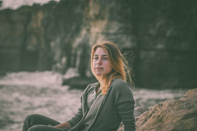 Portrait of woman against rock formation