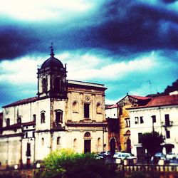 Low angle view of building against cloudy sky