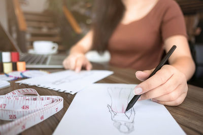 Close-up of woman working on table