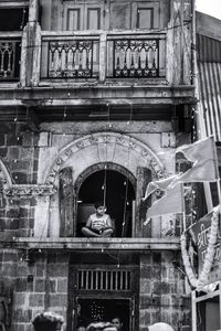 Low angle view of man sitting in building