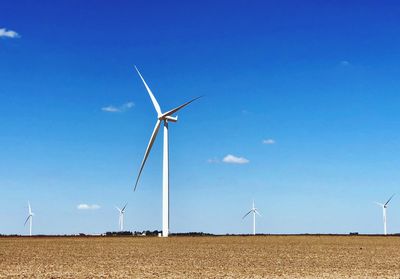 Windmill on field against sky