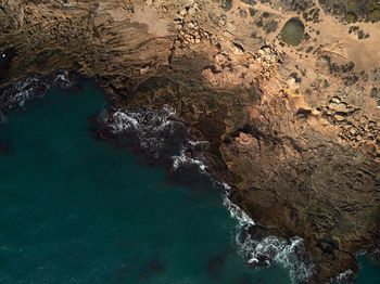 High angle view of rock formation in sea