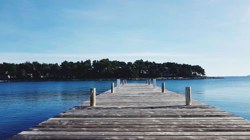 Pier over lake against sky