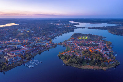 High angle view of townscape by sea against sky