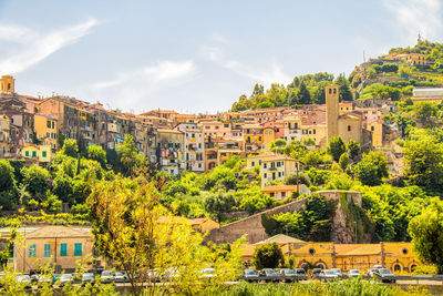 Buildings in town against sky