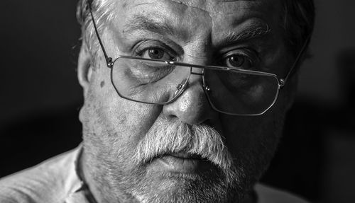 Close-up portrait of man wearing eyeglasses